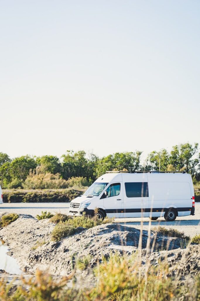 white van on gray concrete road during daytime